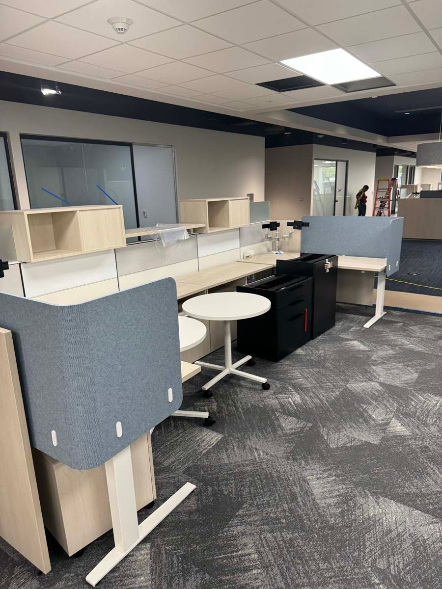 A room with a lot of desks and chairs in it.