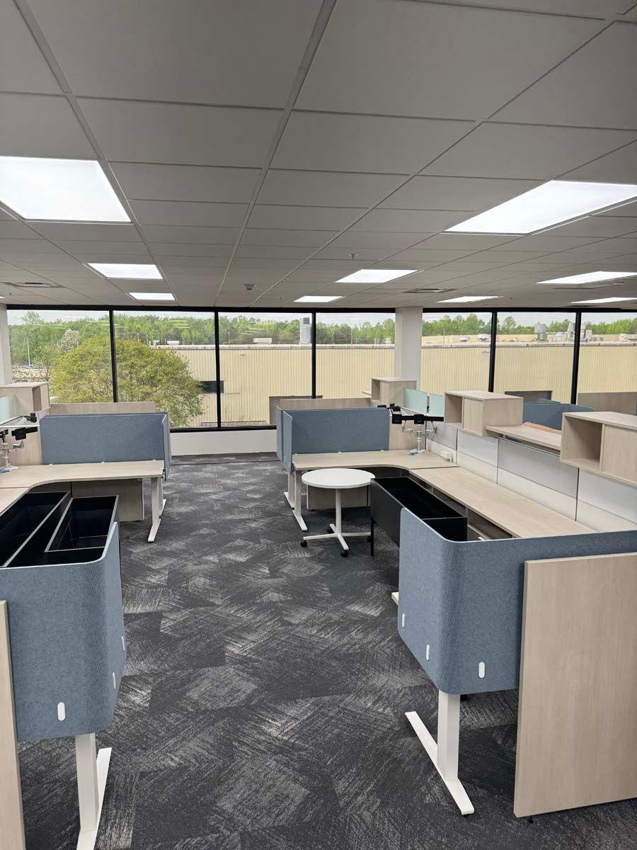 A large office with a lot of desks and windows.