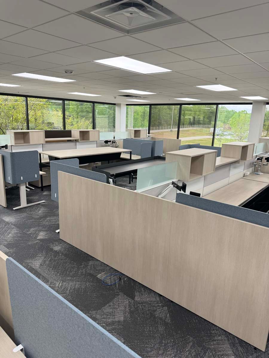 A large office with lots of cubicles and desks.
