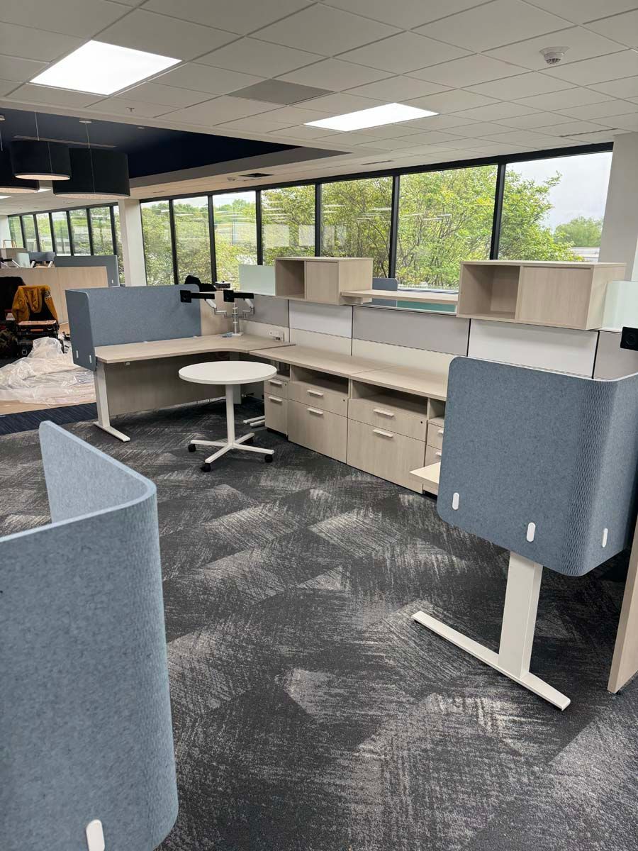 A large office with a lot of desks and cubicles.