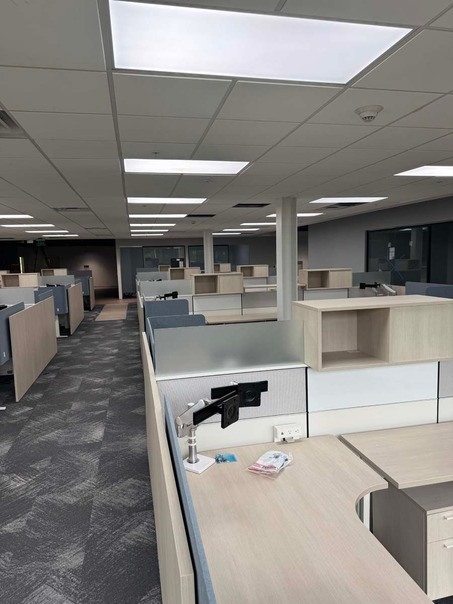 A large office with a lot of cubicles and desks.