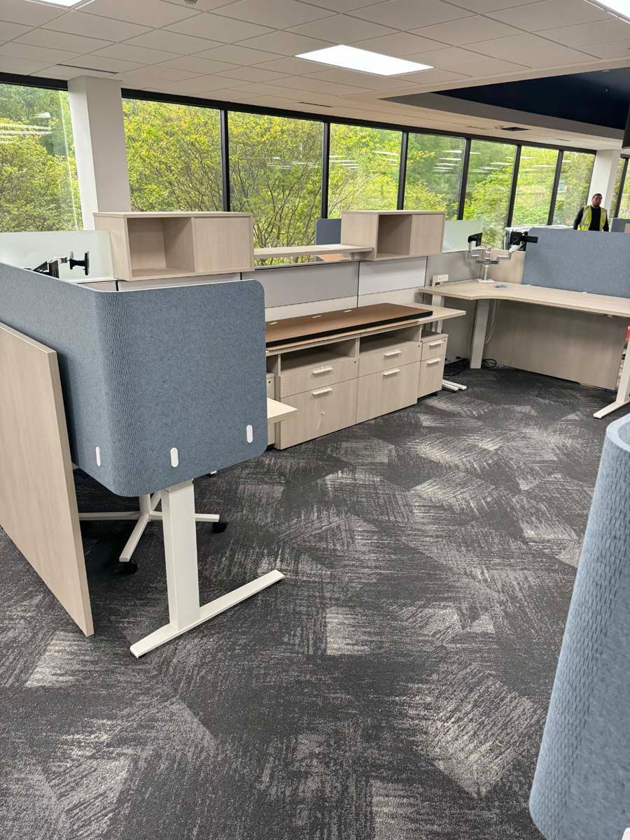 A large office with a lot of desks and cubicles.