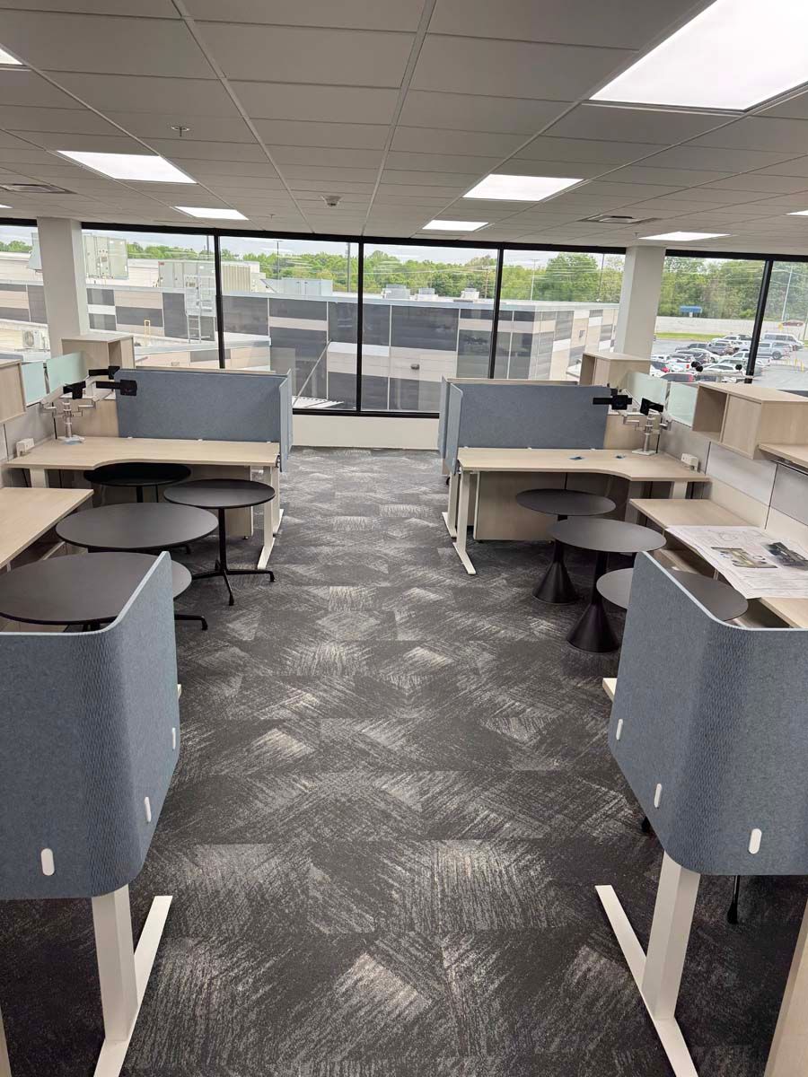 A large office with a lot of desks and chairs.