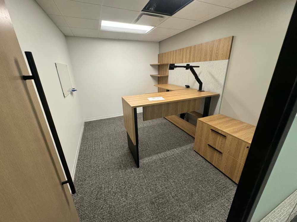 There is a desk in the middle of the room.