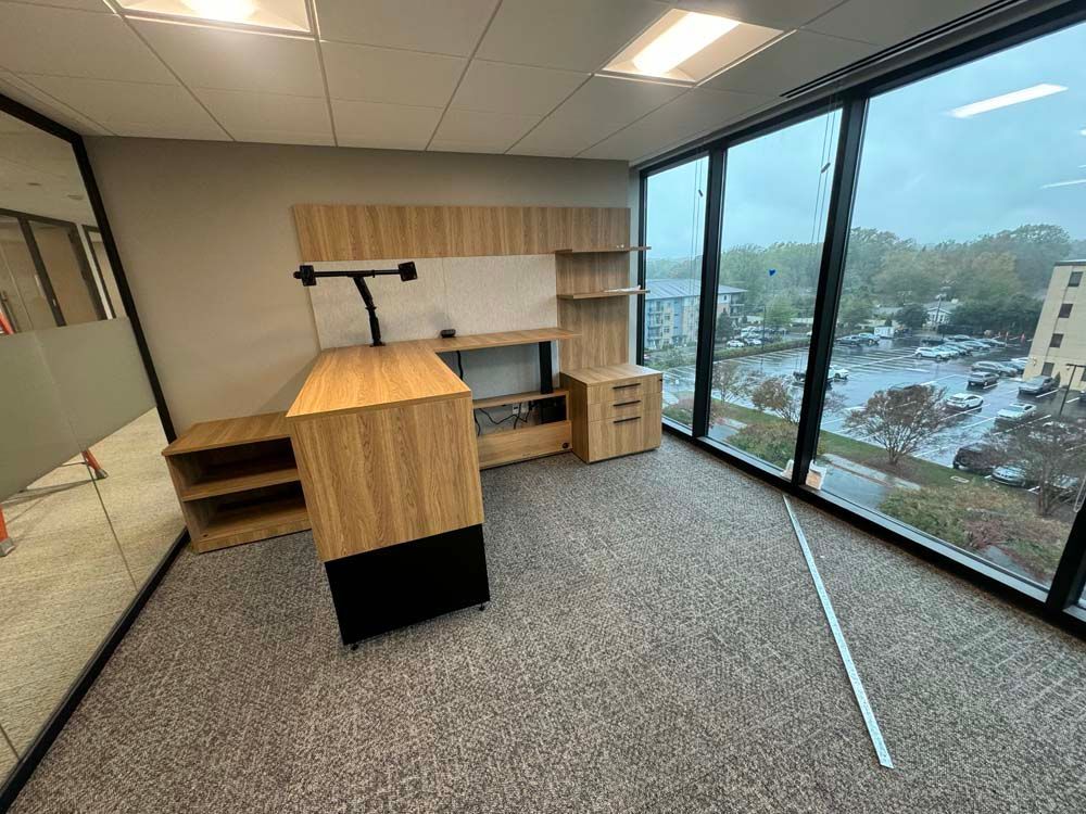 A room with a lot of windows and a desk in it.