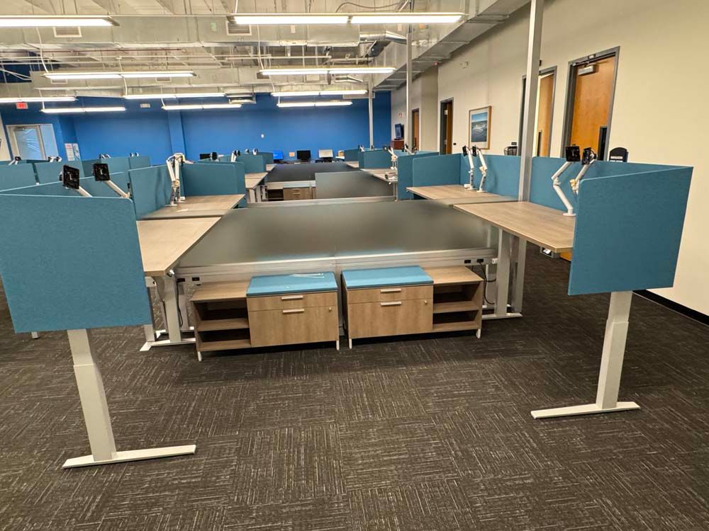 A large office with a lot of desks and cubicles.