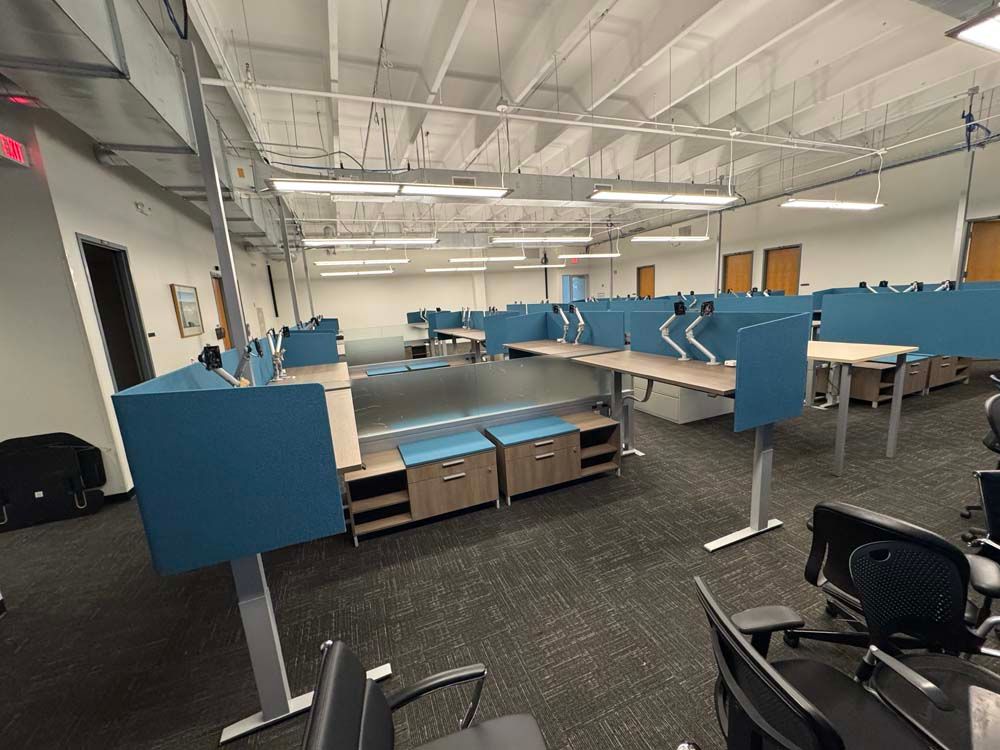 A large office with a lot of desks and chairs.