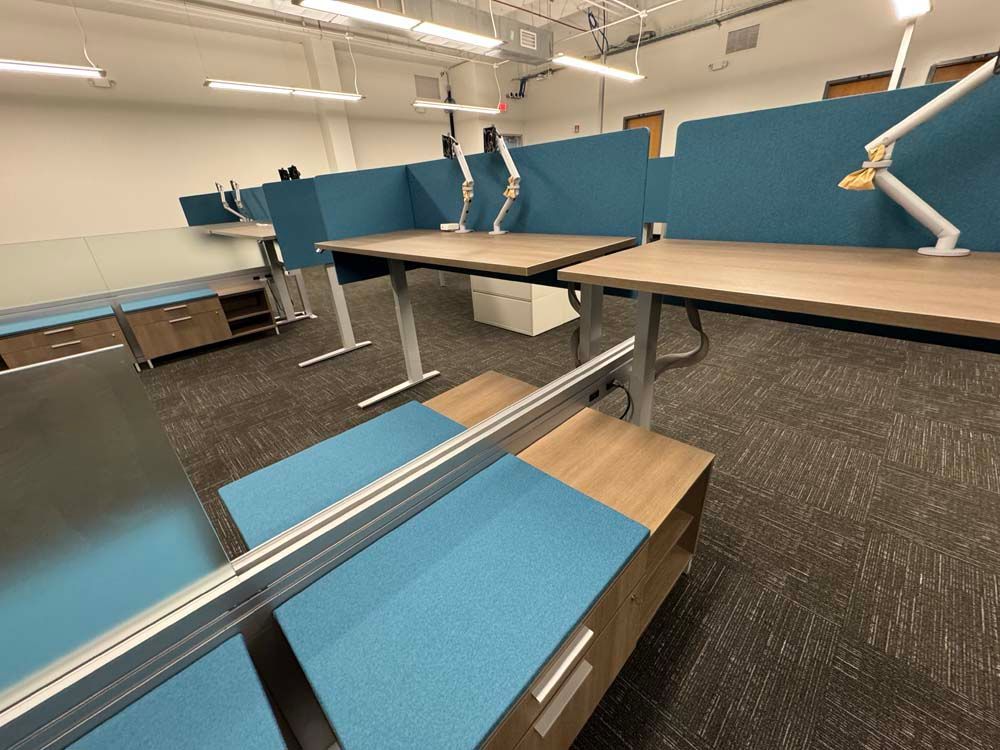 A room with a lot of desks and a mirror.