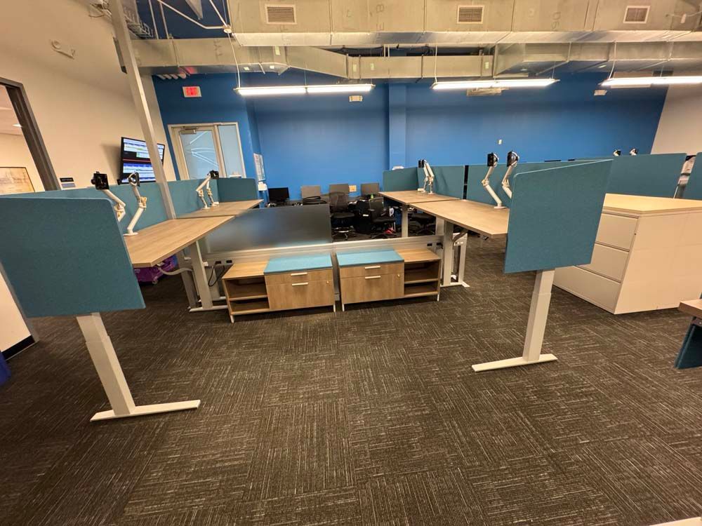 A room with a lot of desks and a blue wall