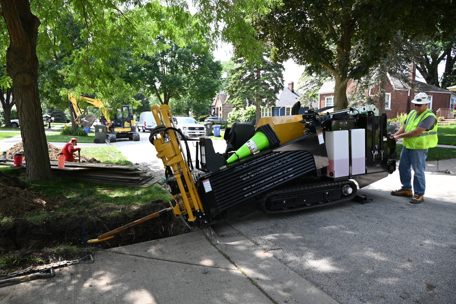 the fair plumber doing a water service installation with directional boring machine 