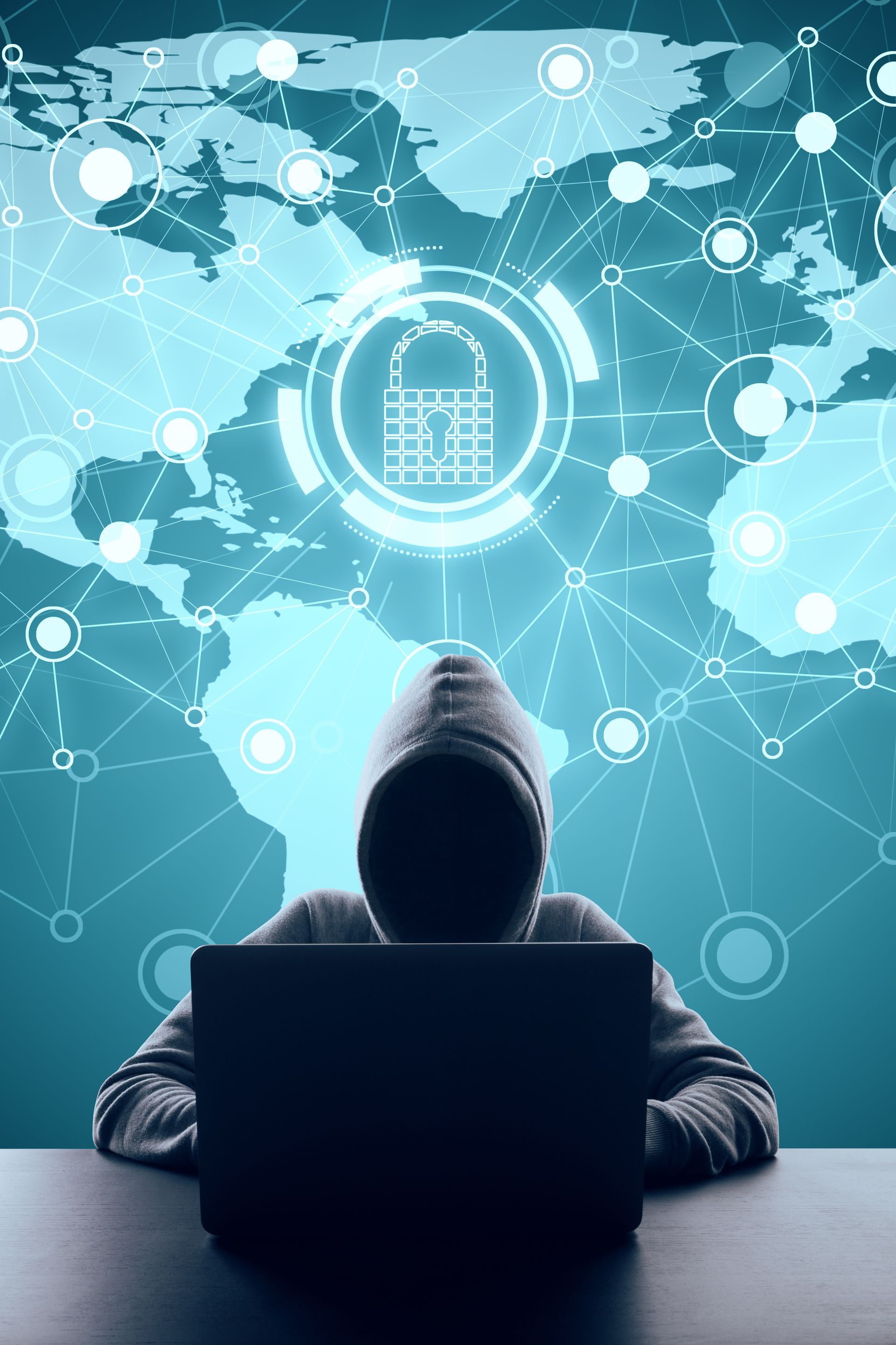 A person in a hoodie using a laptop, with a digital padlock icon over a world map background, lit in blue.