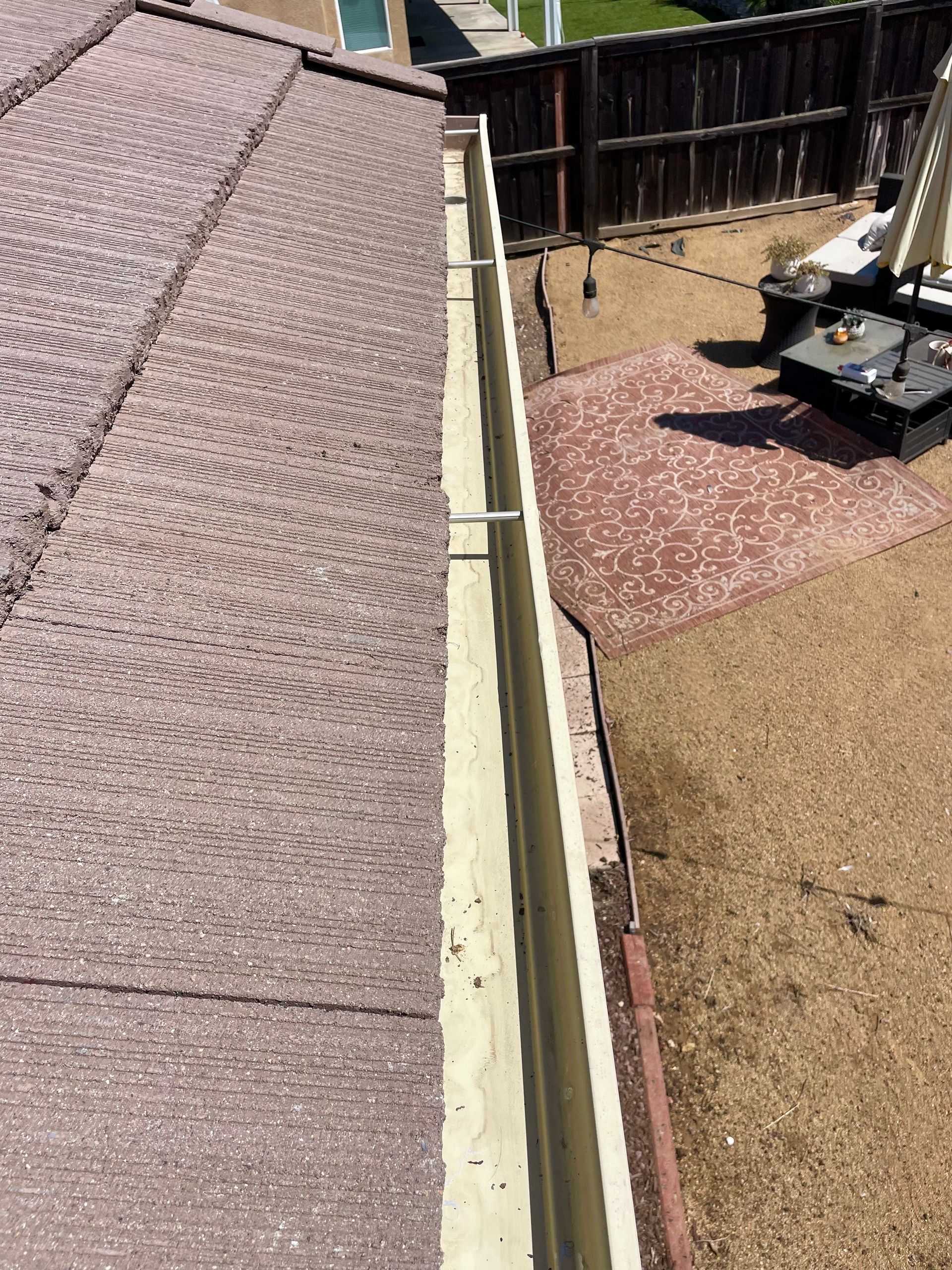 A gutter is attached to the roof of a house.