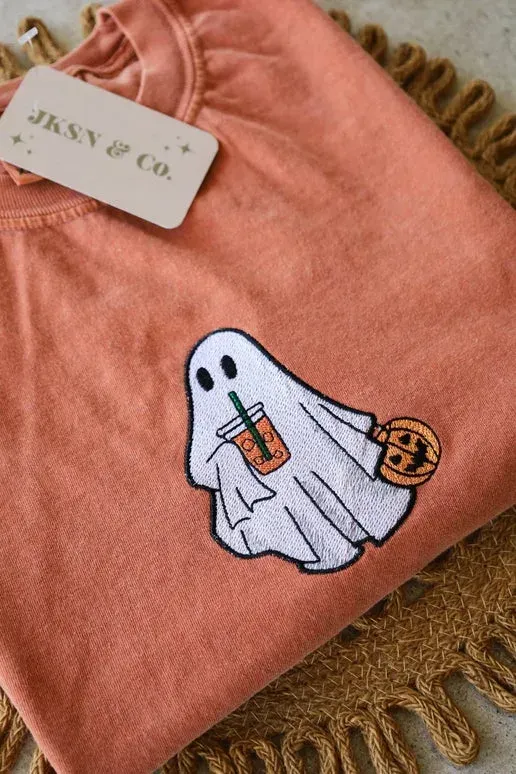 Orange shirt with a ghost holding a pumpkin and a drink.