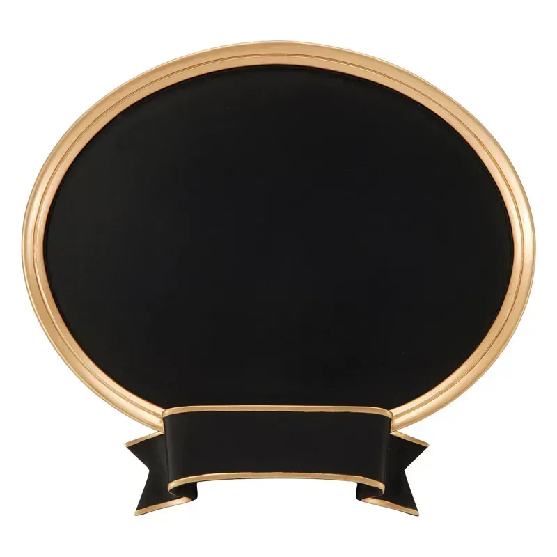 An oval black chalkboard with a gold frame and a decorative black ribbon banner at the bottom for labels.