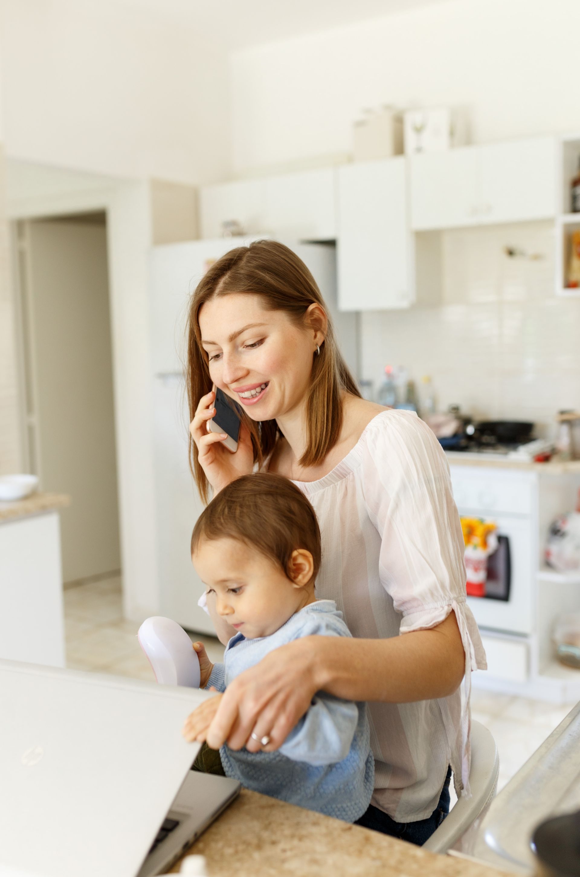 A woman is sitting at a desk with a computer and a sign that says ksw