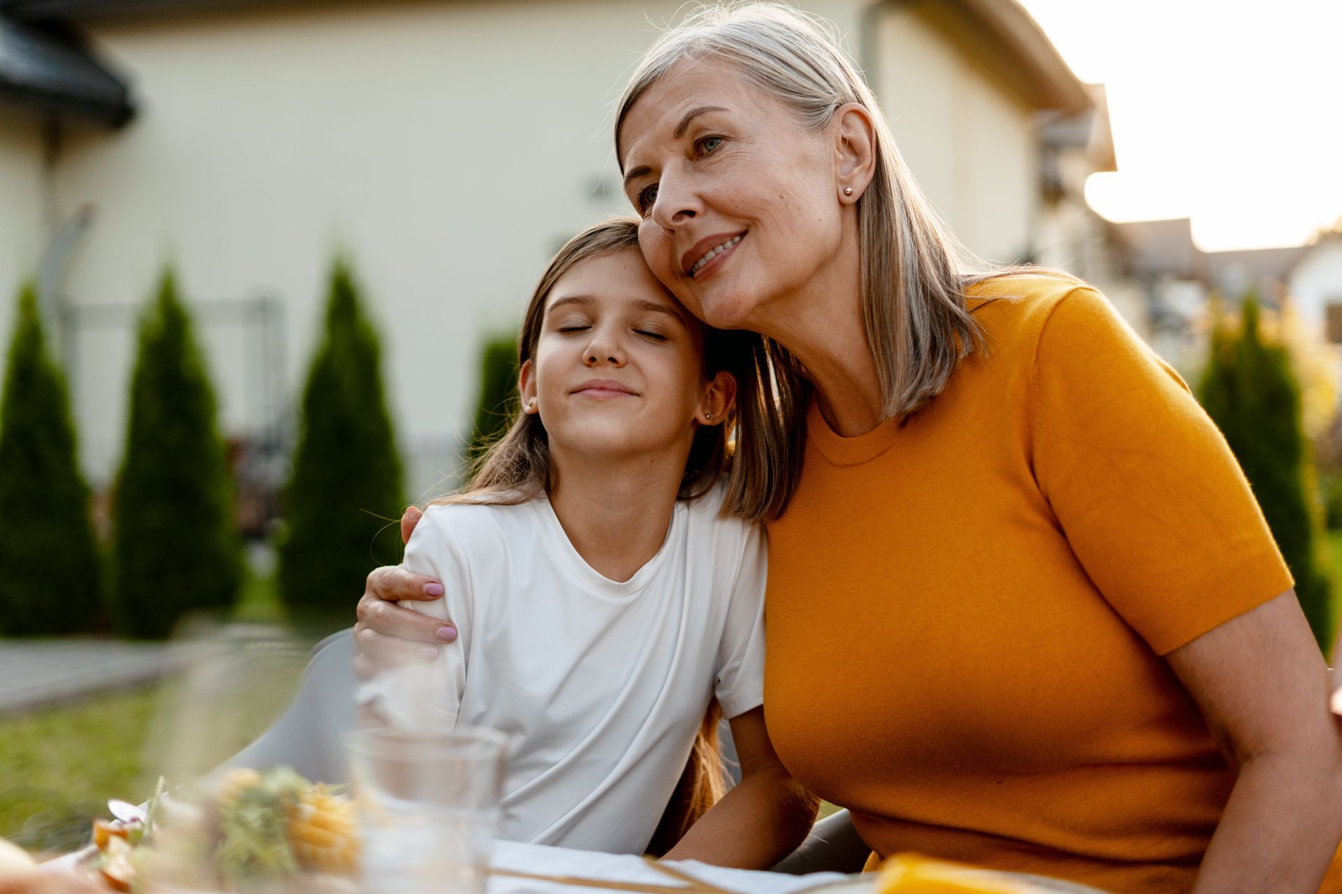 A woman is sitting at a desk with a computer and a sign that says ksw