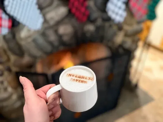 Hand holding a white mug with