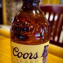 Close-up of a Coors Golden Lager bottle with a tan label.