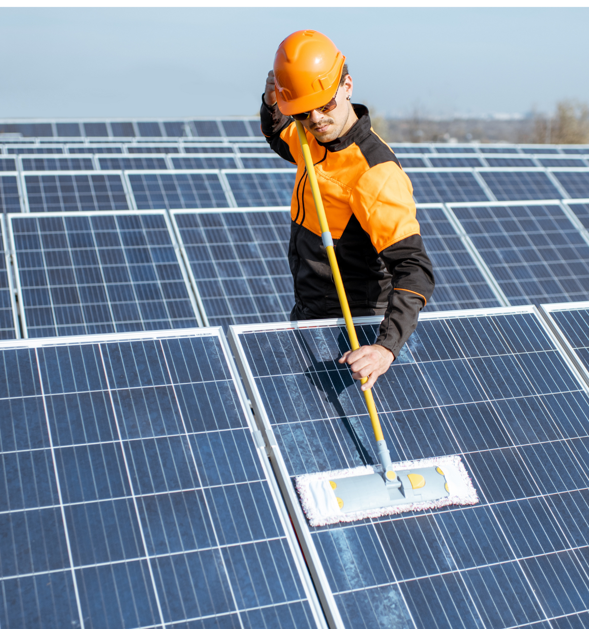 man cleaning solar panels at a solar panel farm outside of Houston, Texas