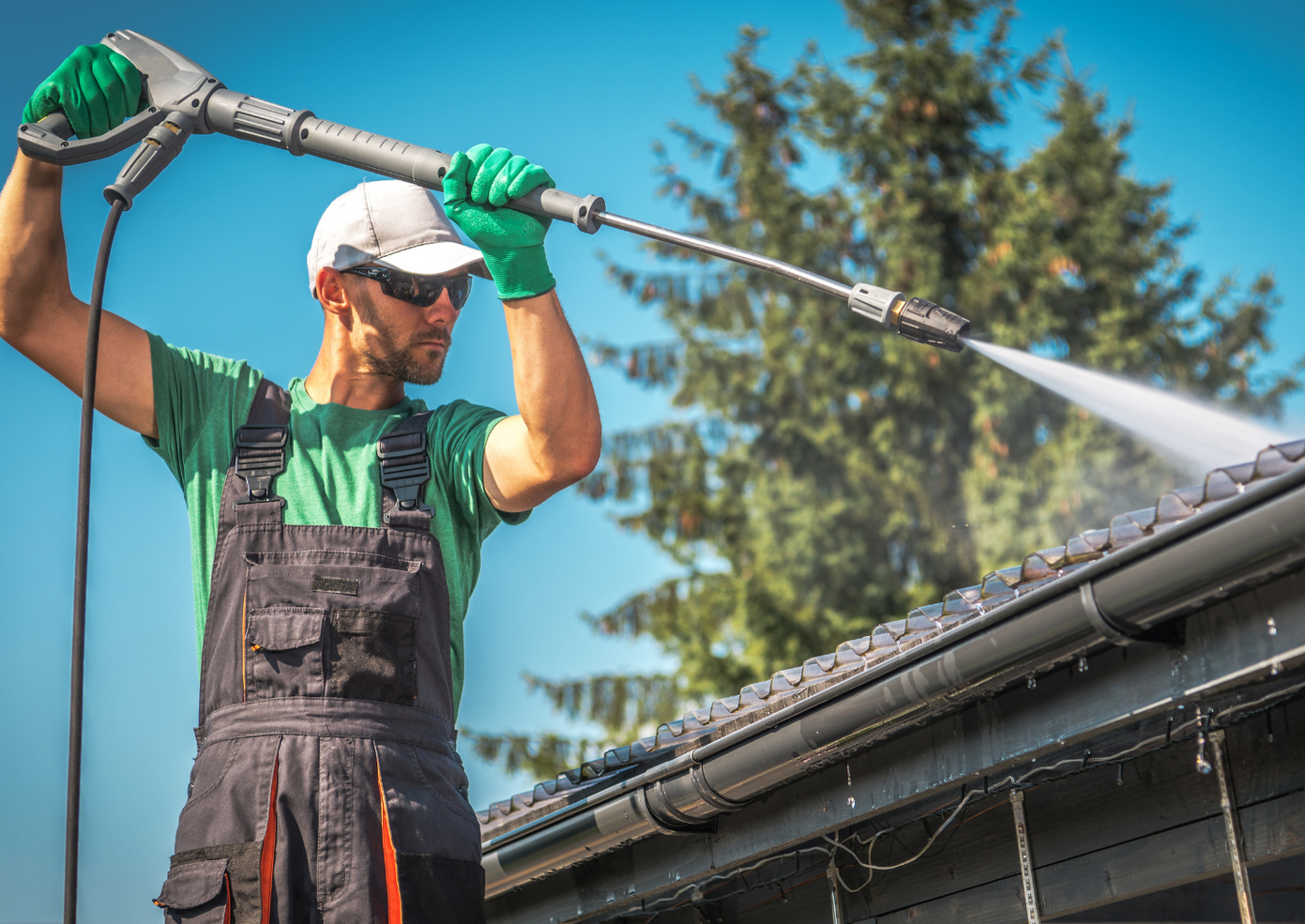 Using a pressure washer to clean gutters In Houston, texas