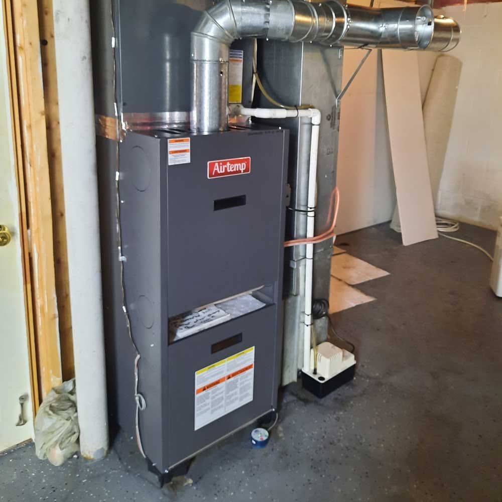 Airtemp furnace installed in a basement as part of a modern HVAC upgrade in a Delaware County home