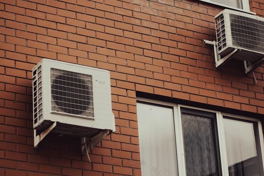 An HVAC system attached to a brick wall