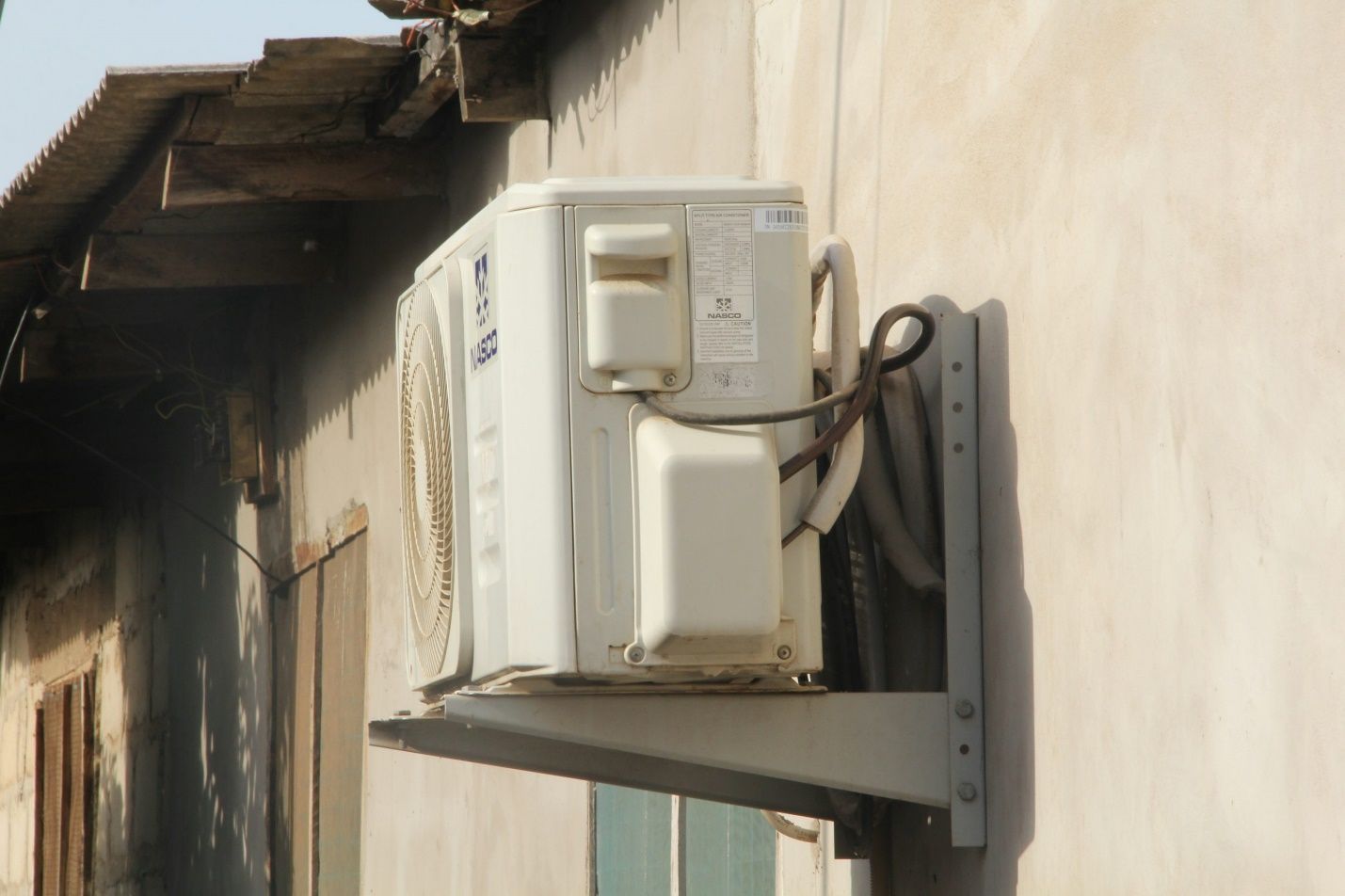 The outdoor part of an HVAC system in a house.