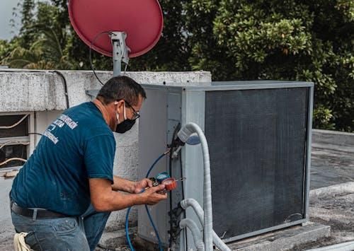 Man checking outer of an air conditioner
