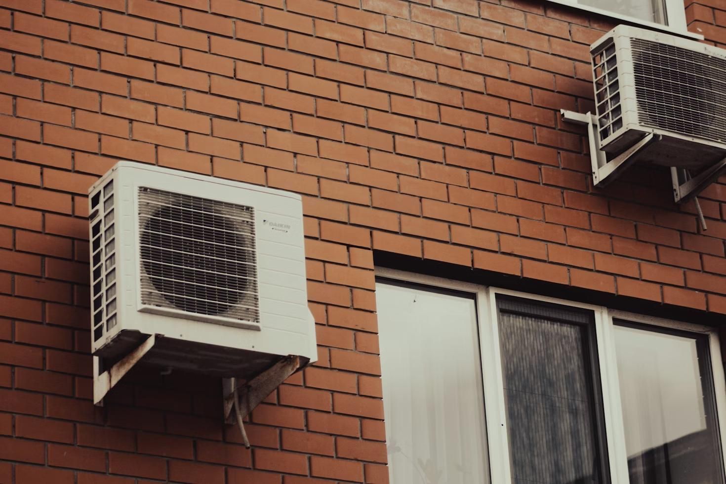 Air conditioning units mounted outside on a wall 