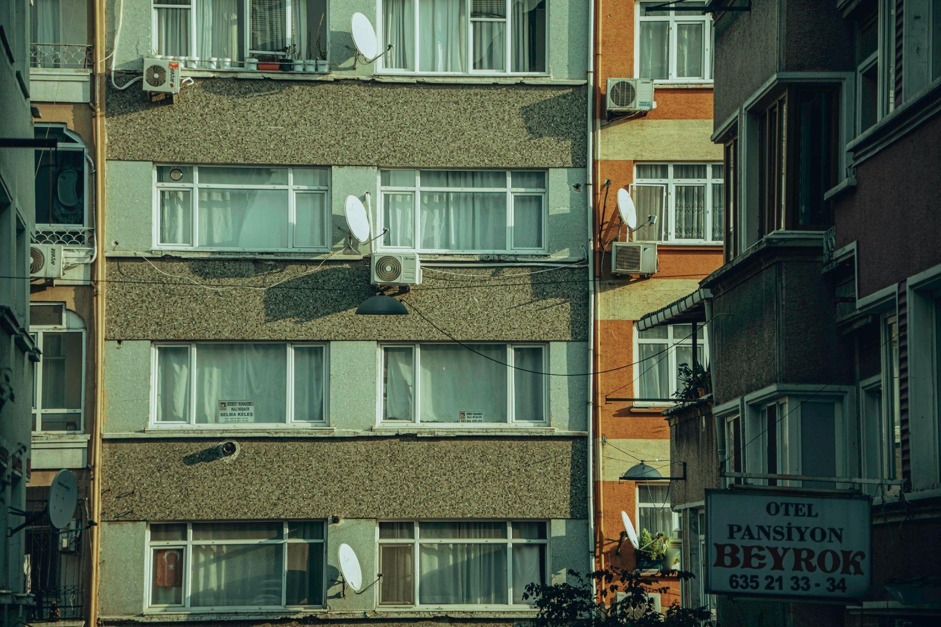 This photo shows a building with multiple air conditioning units attached 
