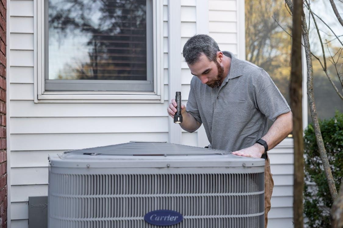 A professional inspects an HVAC system.