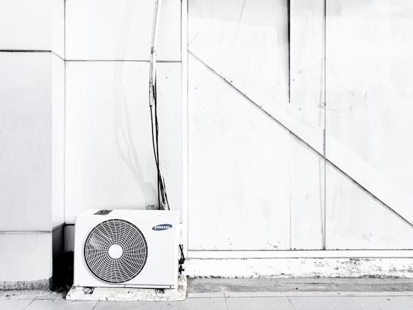 an HVAC unit placed near a white wall.