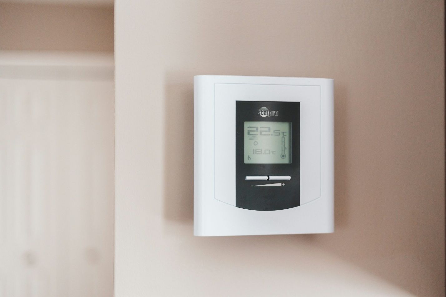 Wall-mounted thermostat displaying temperature settings in a Delaware County home.