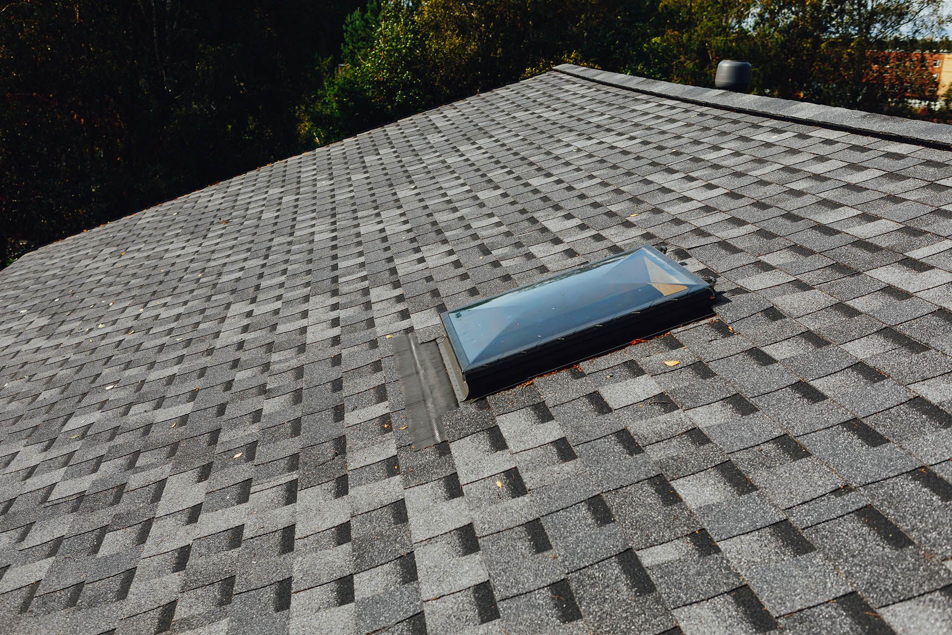 There is a skylight on the roof of a house.