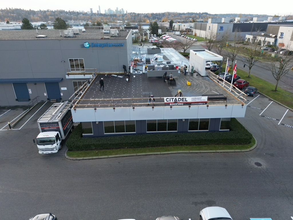 an aerial view of a building with a sign that says citadel roofing
