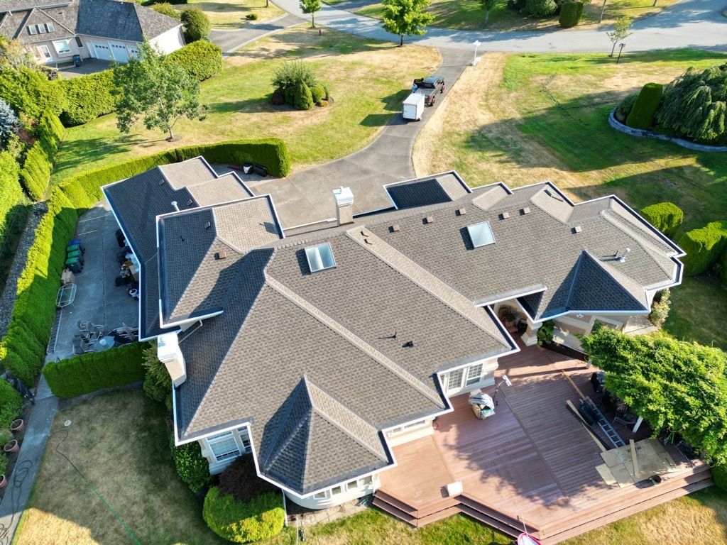 An aerial view of a large house in a residential area.