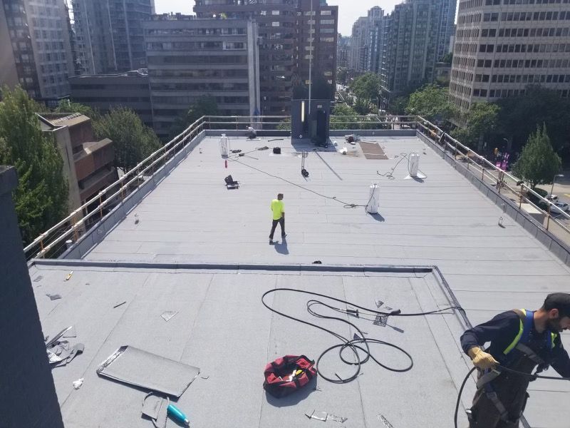 A man is working on the roof of a building
