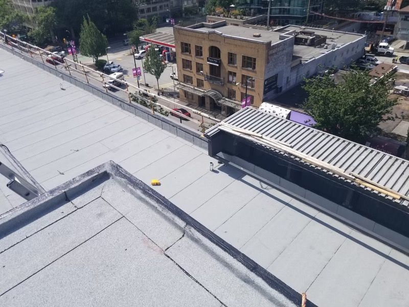 An aerial view of a roof with a building in the background