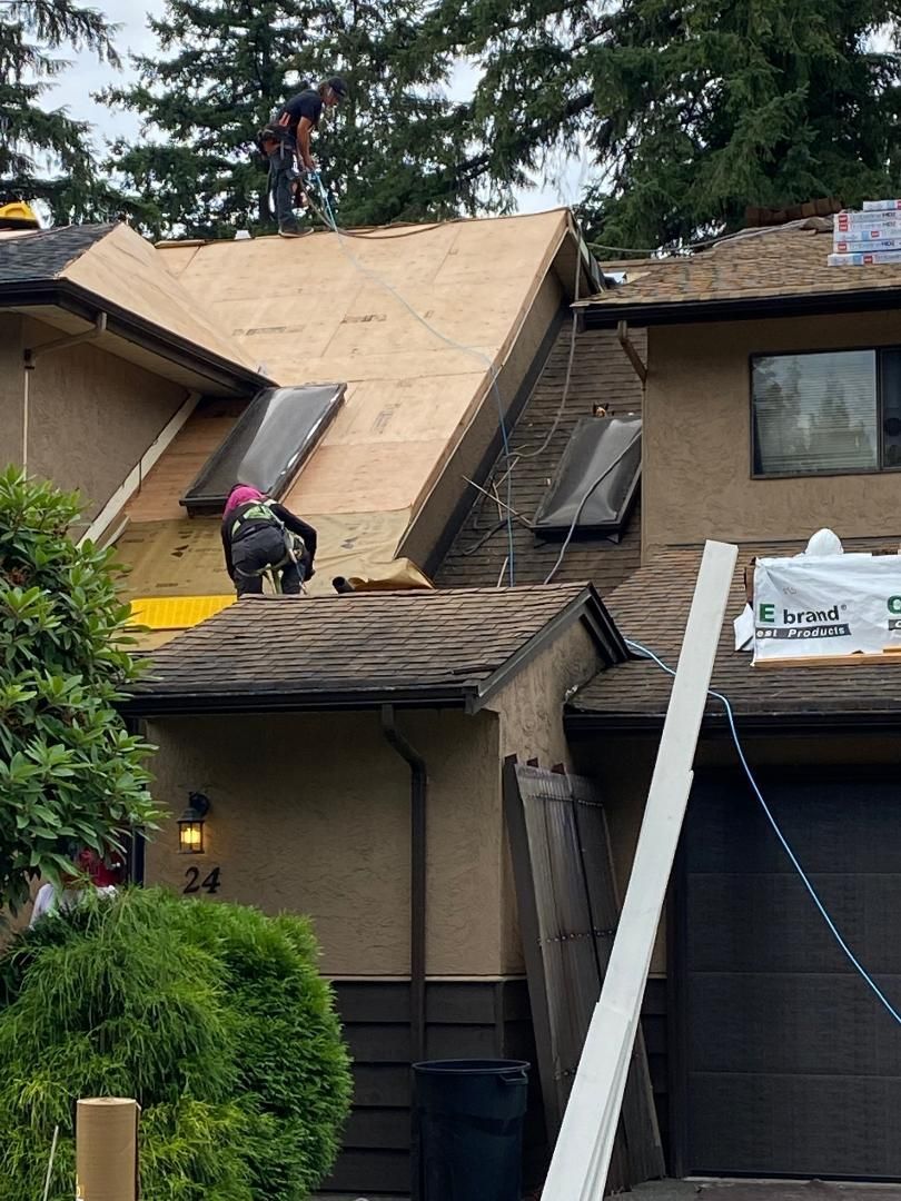 A man is working on the roof of a house.