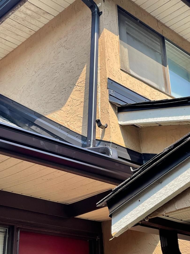 A house with a gutter on the side of it