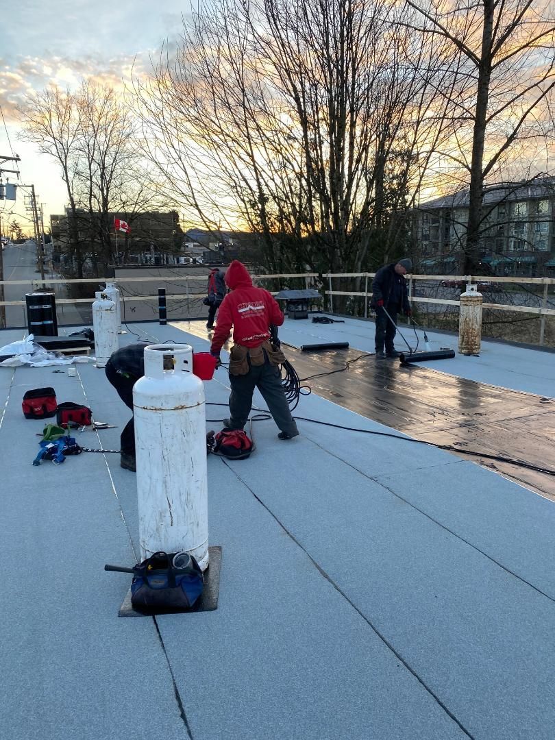 A group of people are working on a roof.