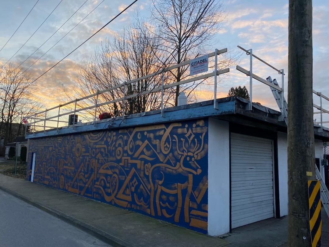 A blue and white building with graffiti on the side of it.