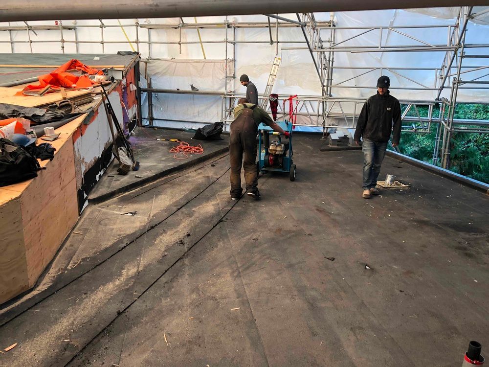A group of people are working on a roof.
