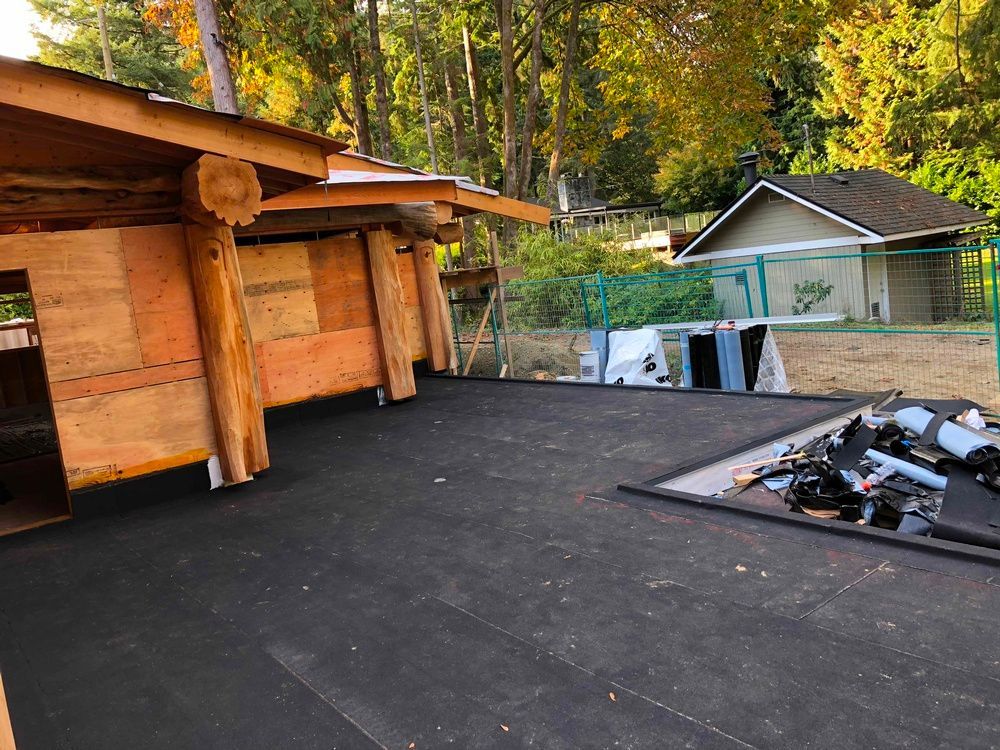 A wooden structure is being built next to a house.