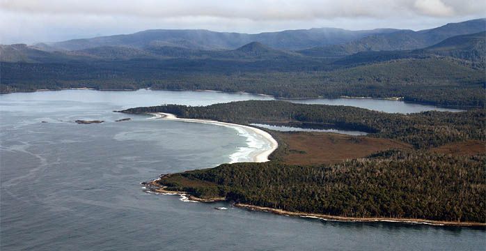 An aerial view of a body of water with mountains in the background