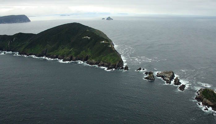 An aerial view of a small island in the middle of the ocean.