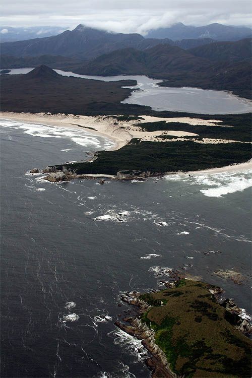 An aerial view of a large body of water with mountains in the background