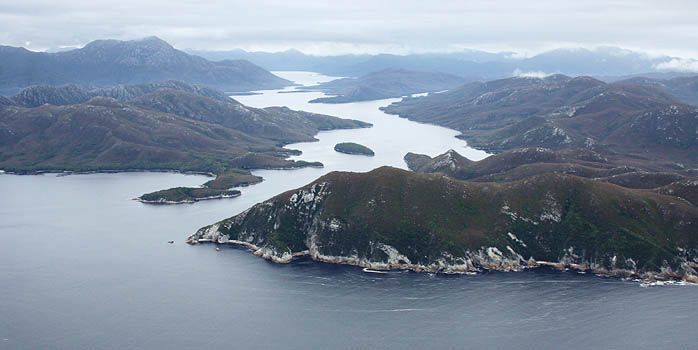 An aerial view of a large body of water surrounded by mountains.