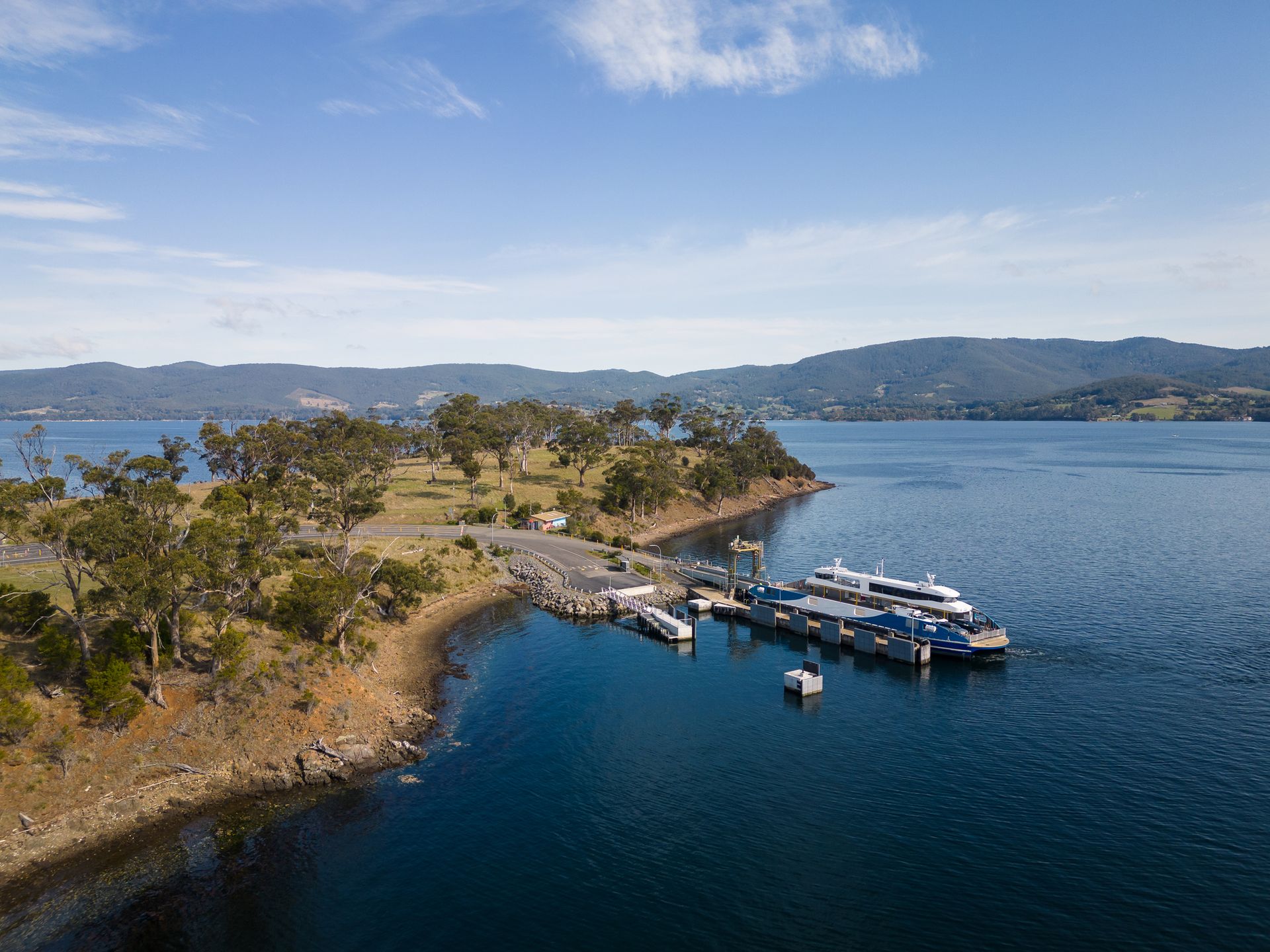 An aerial view of a lake with boats docked on the shore.