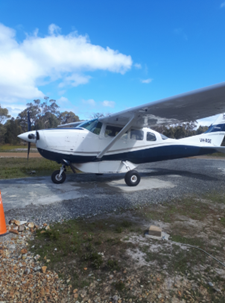 Cessna 206 airplane on the Ground  with a clear blue sky.